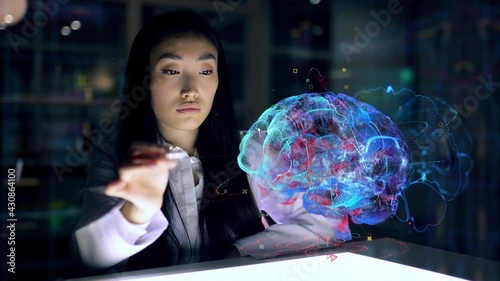 Asian woman Scientist work on 3D Simulated holographic Neural Brain Interface. Engineer using Augmented Holographic Technology. Artificial Intelligence Concept photo