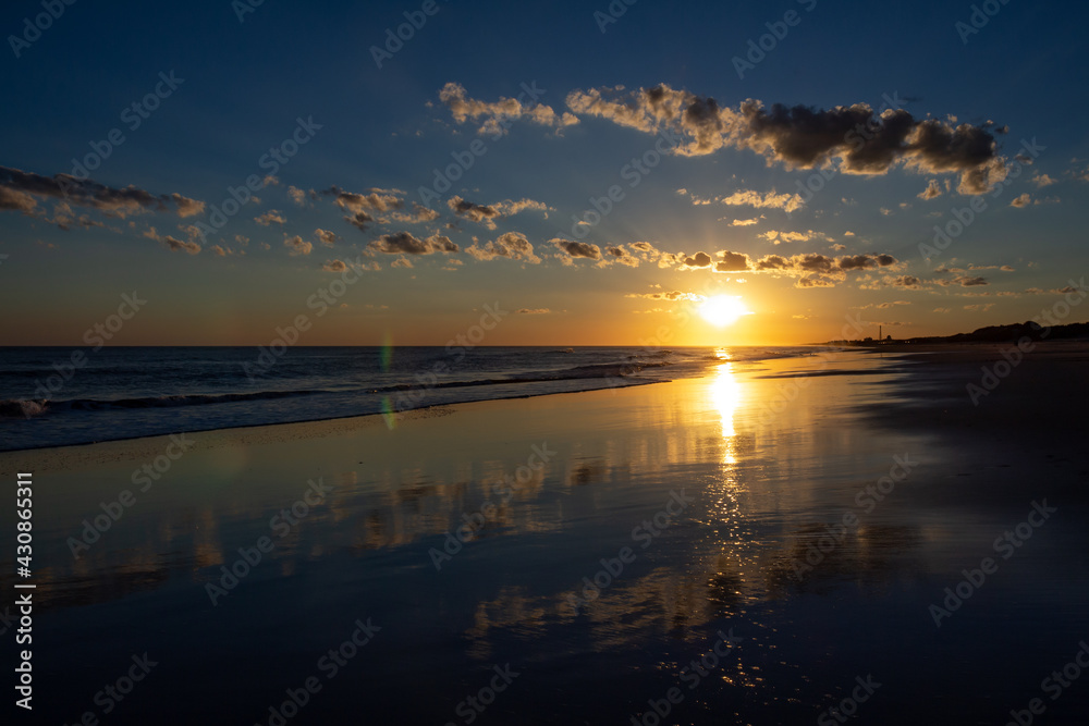 Incredible colors during sunrise. Reflections in the sea water. Holiday landscape.