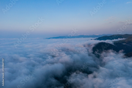 Mountains above the clouds beautiful sunset © Dmitrii