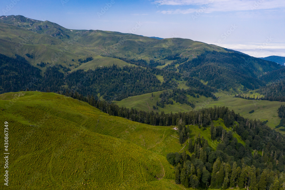 Mountains and green grass view from drone