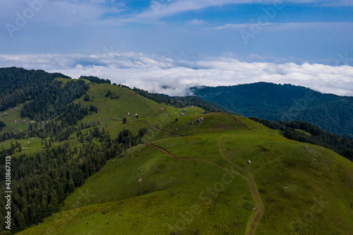 Mountains and green grass view from drone