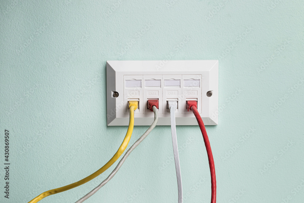 Data CAT6 Double Socket Quad Port Faceplate with four network cables plugged in Data CAT6 Double Socket Quad Port Faceplate with four network cables plugged in