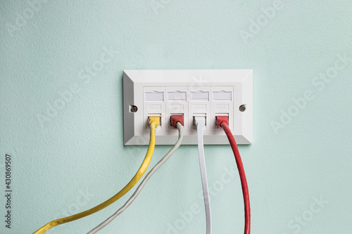 Data CAT6 Double Socket Quad Port Faceplate with four network cables plugged in