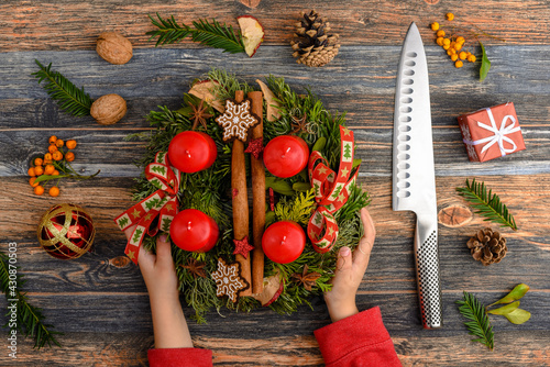 Child hands hold the Advent wreath