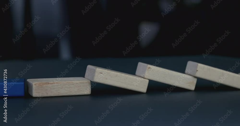 4K Video slow motion close up domino effect to blue block. business concept of the domino effect and targeting.