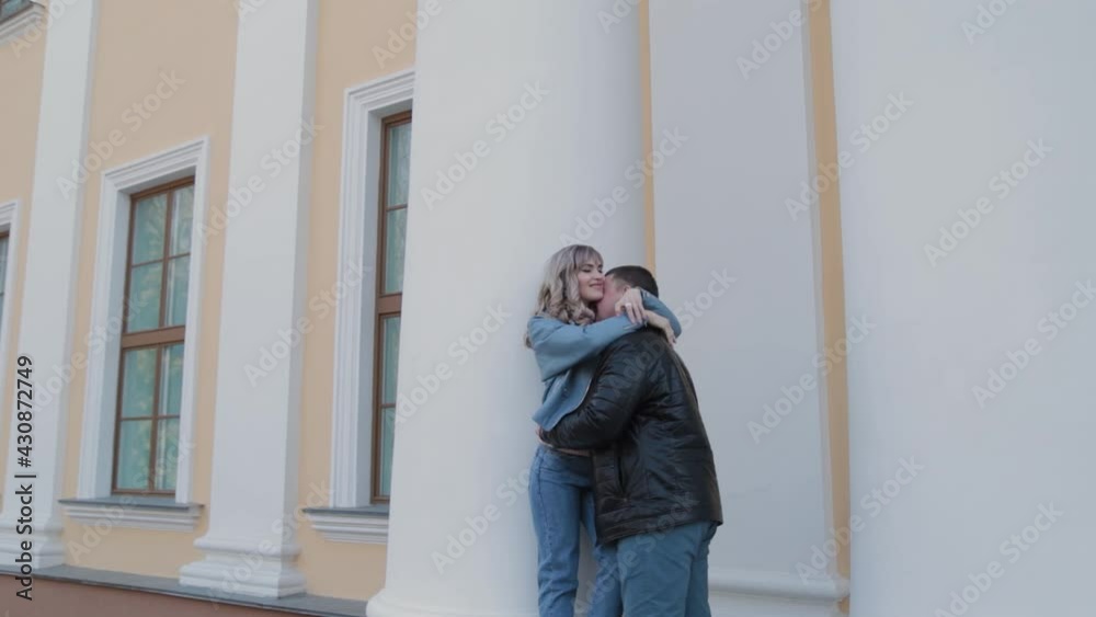 Couple in love hugs at the columns in the park. Couple in love hugs at the columns in the park.