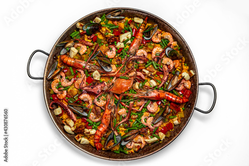Paella. Huge frying pan. Spanish dish of rice and seafood, vegetables and chicken. Shrimp, octopus, crab and mussels. Banquet festive dishes. Gourmet restaurant menu. White background.