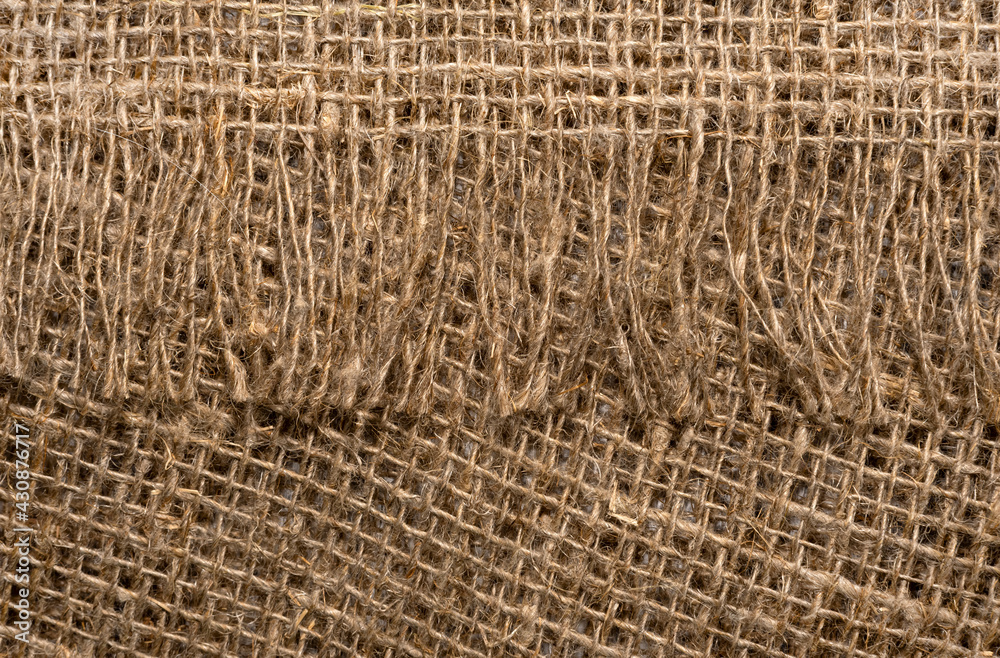Cloth. The texture of the burlap fabric is close-up. Packaging material. Background Of Burlap Hessian Sacking Cloth. The texture of the burlap fabric is close-up. Packaging material. Background Of Burlap Hessian Sacking