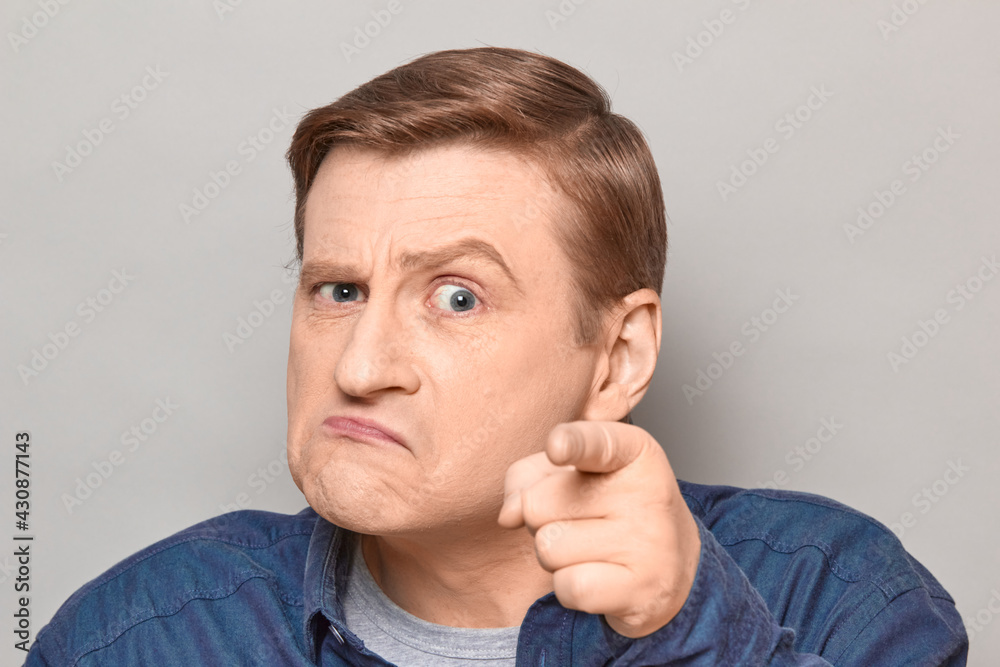 Portrait of angry annoyed man with pointing with index finger at you Portrait of angry annoyed man with pointing with index finger at you