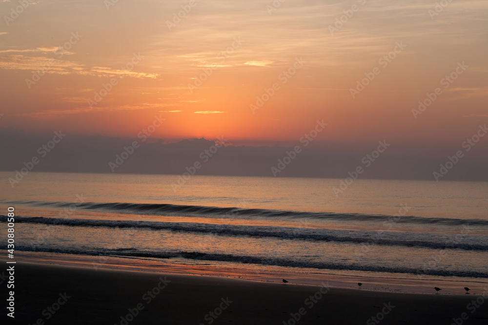 sunrise reflected in the ocean surf