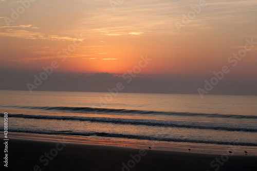sunrise reflected in the ocean surf © Allen Penton