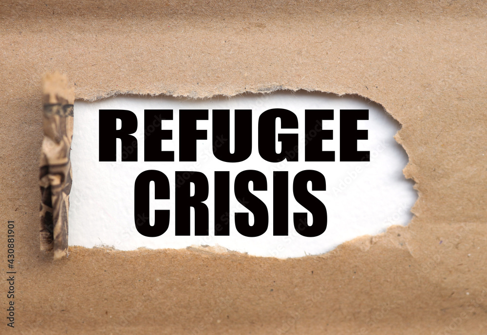 Obraz premium Refugee Crisis. Business concept. text on white paper, torn paper near the text.