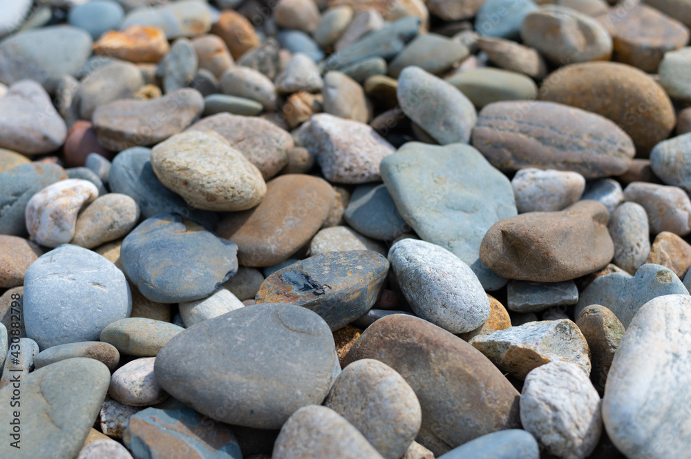 background of gray and red stones on the beach in the afternoon in the sun in summer. High quality photo background of gray and red stones on the beach in the afternoon in the sun in summer. High quality photo
