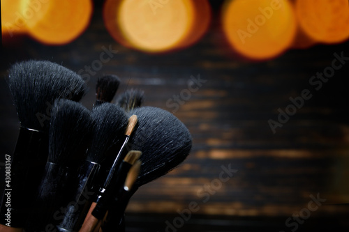 makeup brushes on a dark wooden background.selective focus. High quality photo © Margo_Alexa