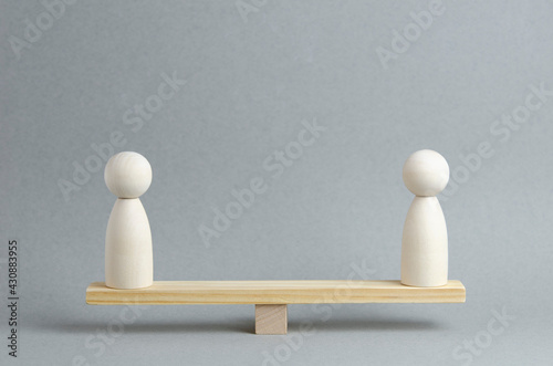 Relationship crisis, conflict of people concept. Human images stand on a wooden board on a gray background.