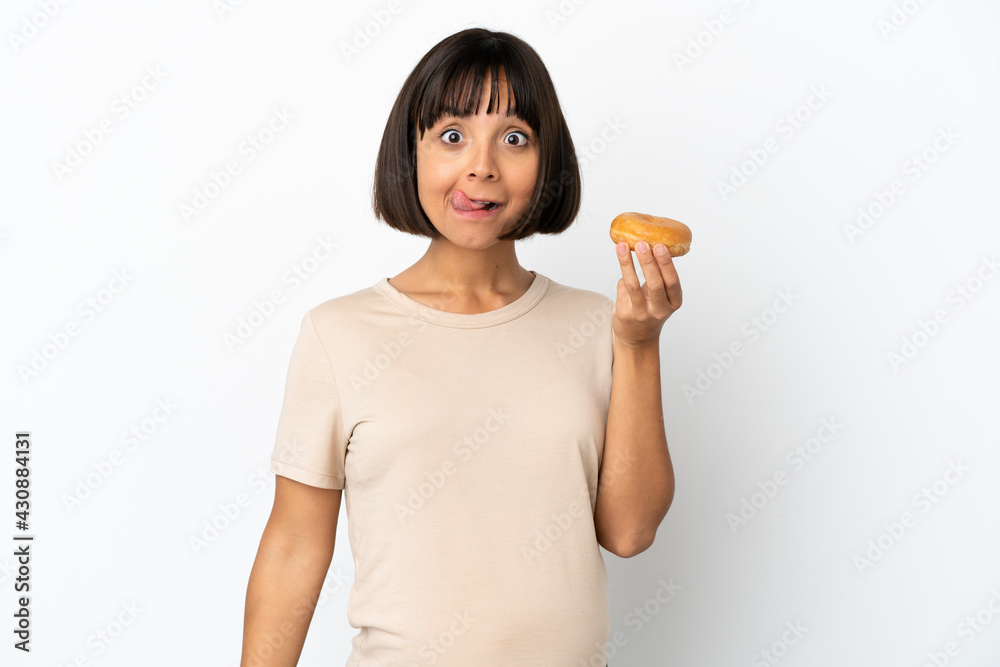 Young mixed race pregnant woman isolated on white background holding a donut Young mixed race pregnant woman isolated on white background holding a donut