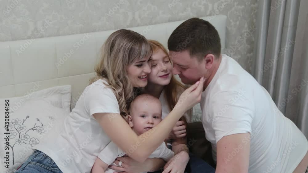 Cheerful happy family on the bed. Cheerful happy family on the bed.
