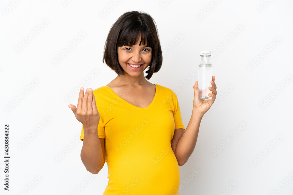 Young pregnant woman holding a bottle of water isolated on white background inviting to come with hand. Happy that you came Young pregnant woman holding a bottle of water isolated on white background inviting to come with hand. Happy that you came