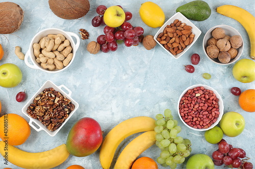 Fresh summer tropical fruits and nuts assortment on a bright sunny table, citrus mix, detox diet and weight loss concepts, banner, advertising for a store, healthy and natural food, selective focus