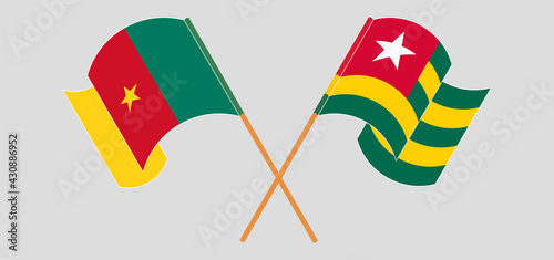 Crossed and waving flags of Cameroon and Togo