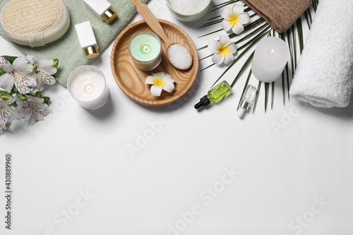 Flat lay composition with spa essentials on white background. Space for text