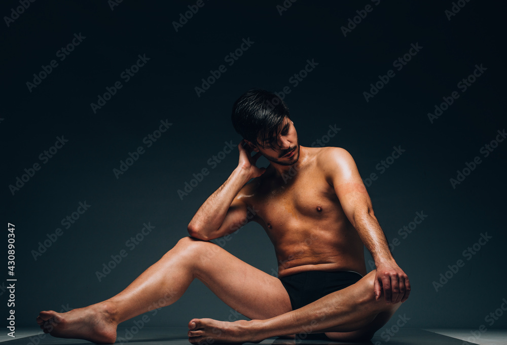 Handsome man posing in underwear on dark background Handsome man posing in underwear on dark background