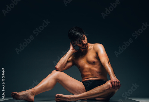Handsome man posing in underwear on dark background