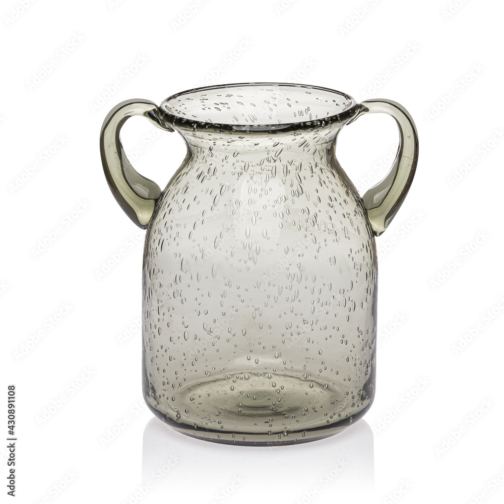 Glass transparent jug of brown color with two handles for drinks on a white isolated background. Glass transparent jug of brown color with two handles for drinks on a white isolated background.