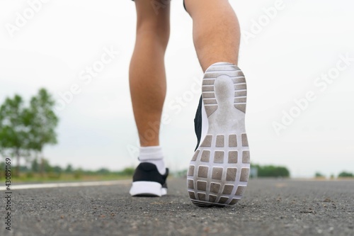Sport running feet on road - healthy concept