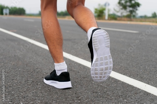 Sport running feet on road - healthy concept