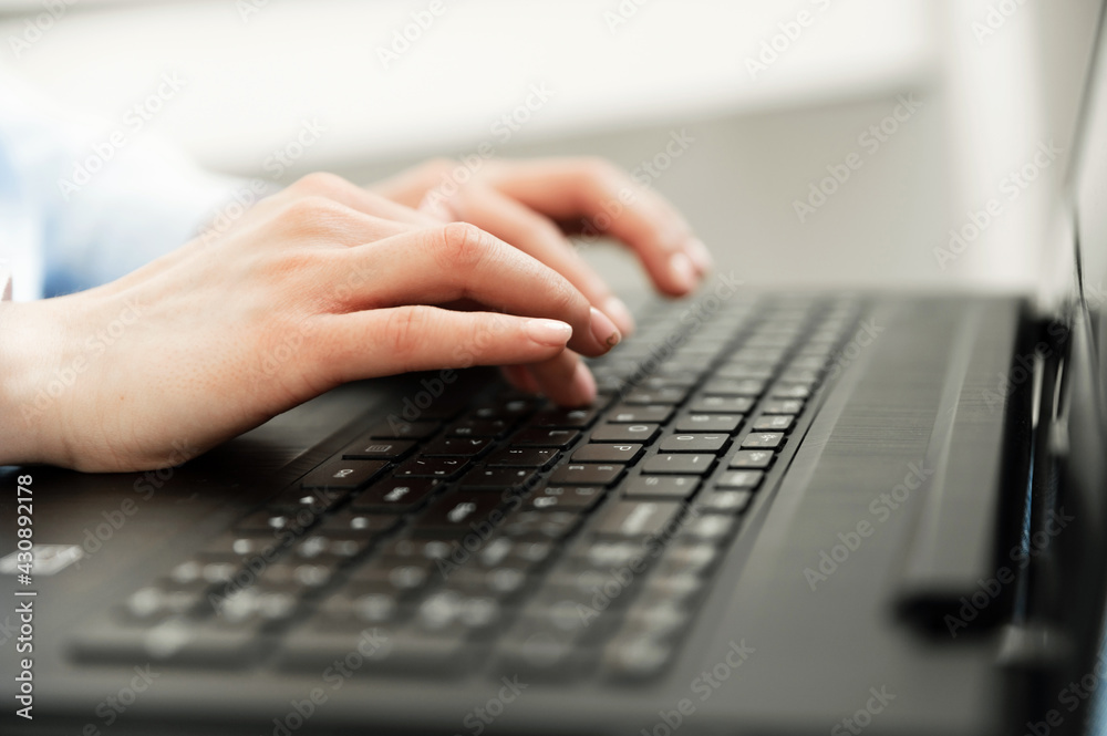 close-up of female hands. typing hands in the process. online work. the process of printing a letter. distance learning. laptop keyboard. hands on the keyboard close-up of female hands. typing hands in the process. online work. the process of printing a letter. distance learning. laptop keyboard. hands on the keyboard