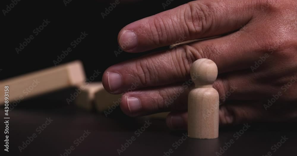 4K Video slow motion close up hand stop domino effect to make employee icon fall . business concept of try to stop the domino effect