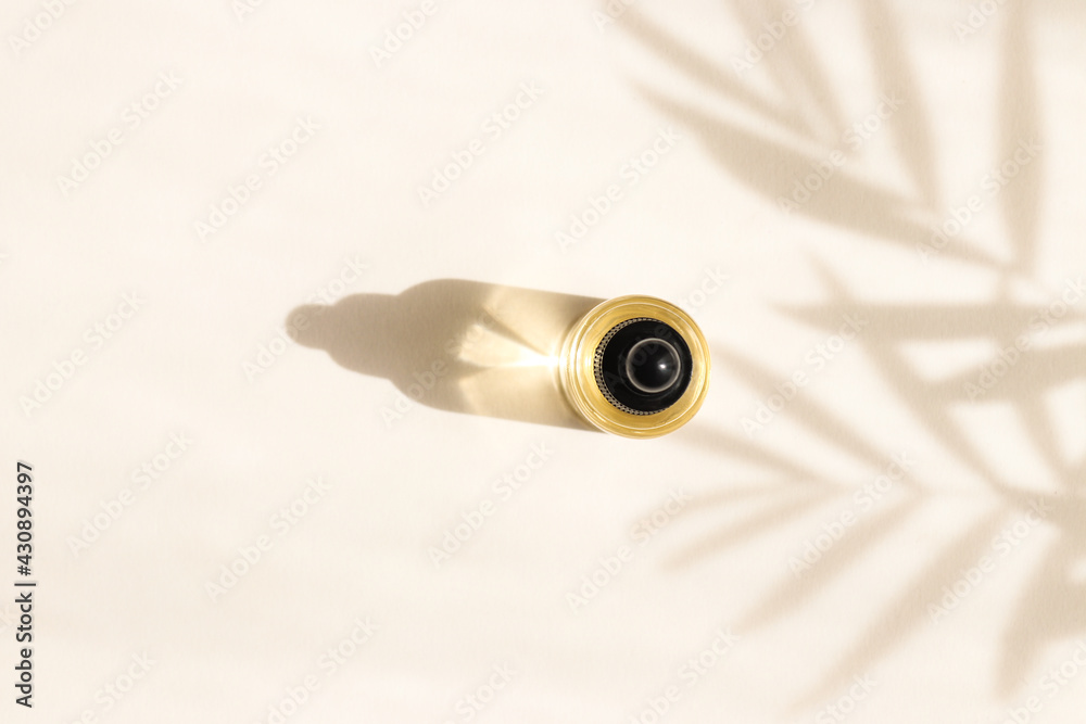 Bottle of cosmetic essential oil with dropper. Hard light. Beauty concept. Serum skin care product. Top view Bottle of cosmetic essential oil with dropper. Hard light. Beauty concept. Serum skin care product. Top view