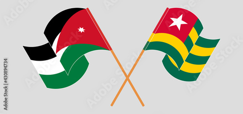 Crossed and waving flags of Jordan and Togo