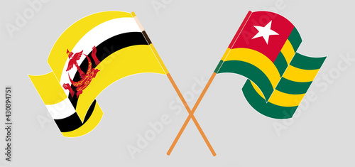 Crossed and waving flags of Brunei and Togo