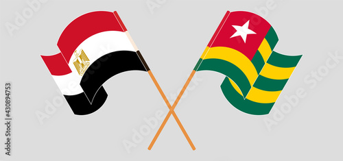 Crossed and waving flags of Egypt and Togo
