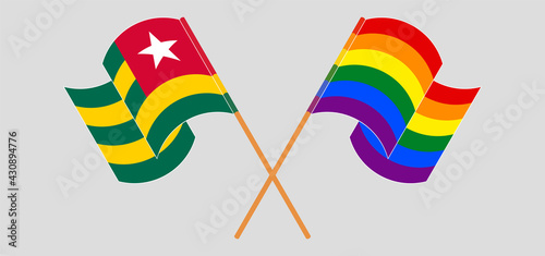 Crossed and waving flags of Togo and LGBTQ