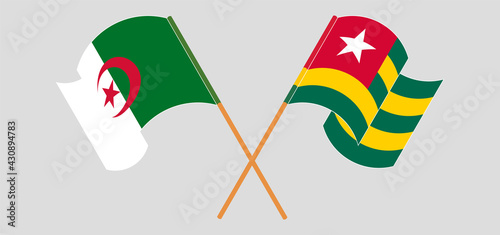 Crossed and waving flags of Togo and Algeria