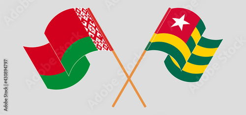 Crossed and waving flags of Belarus and Togo