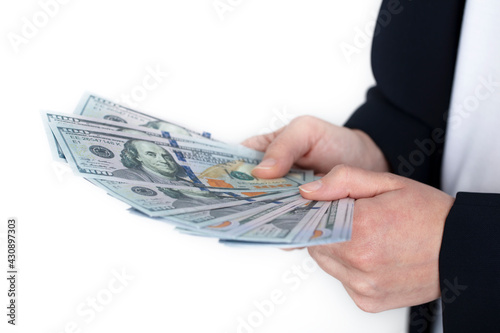 Business woman holding 100 dollars in hand over white background. economy and business concept background, banner.