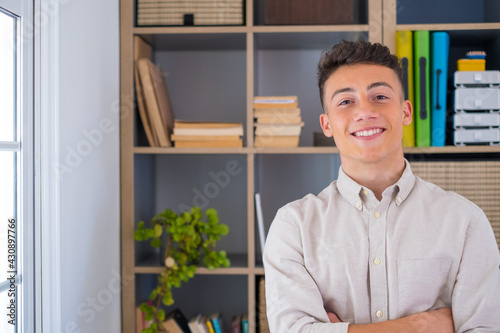 Portrait of one young and happy cheerful man smiling looking at the camera having fun. Headshot of male person working at home in the office..