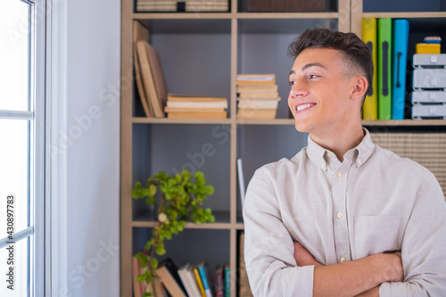 Caucasian smiling man, reflexing on work, businessman independent working in a difficult project. Male teenager preparing at home in the office indoor..