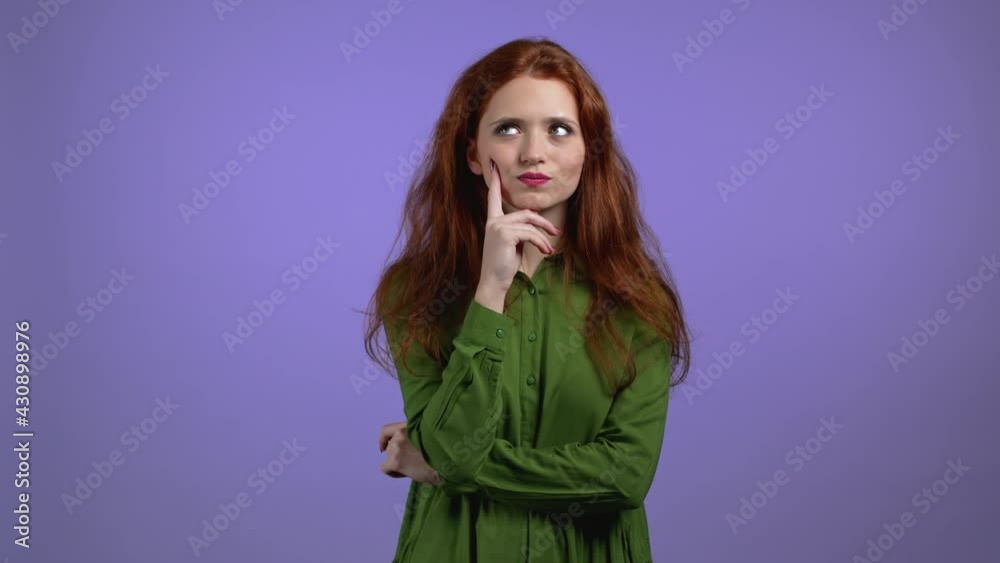 Portrait of woman having idea moment pointing finger up on violet studio background. Smiling happy girl showing eureka gesture. Portrait of woman having idea moment pointing finger up on violet studio background. Smiling happy girl showing eureka gesture.