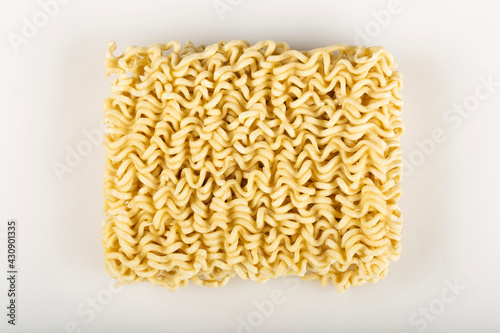 Raw instant noodles on white background.