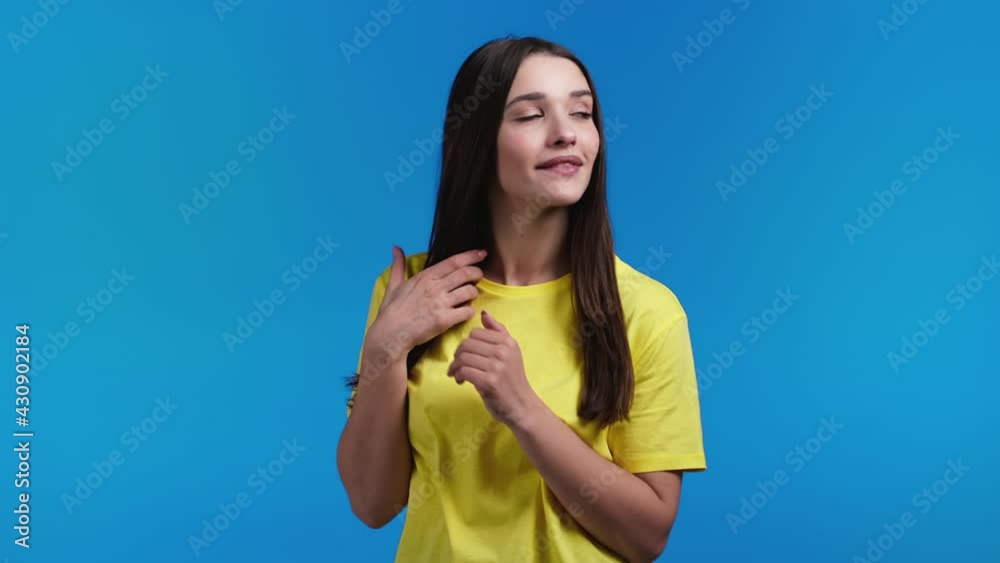 Young woman looking to camera, flirting. Beautiful model lady on blue studio background. Young woman looking to camera, flirting. Beautiful model lady on blue studio background.