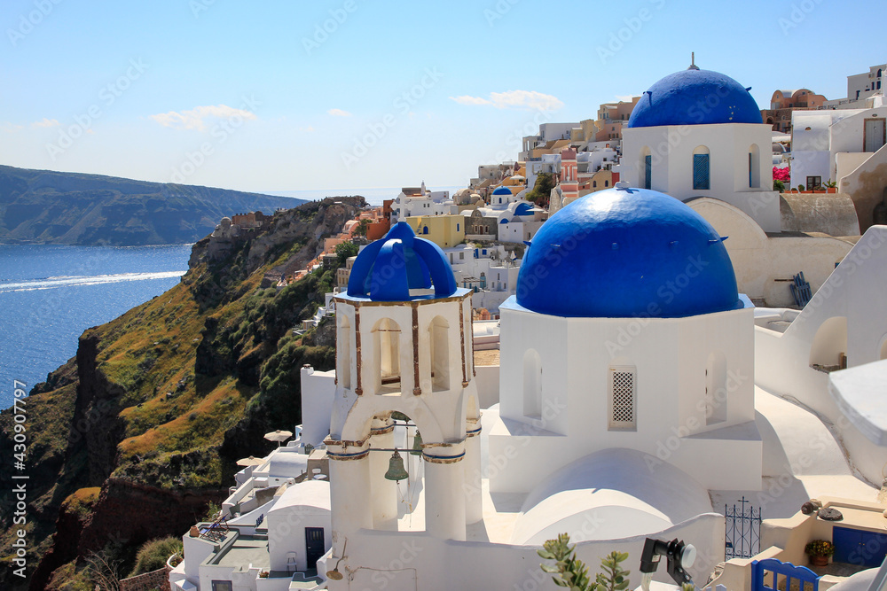 Famous blue domed church of Oia, Santorini, Greece, on the sea 