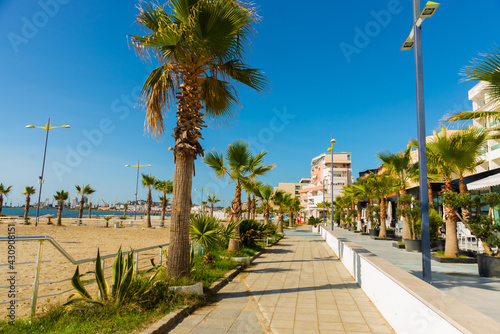 DURRES, ALBANIA: Palm tree promenade and blue sea on the beach in Durres.