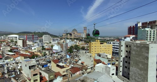 City of Aparecida, São Paulo, Brazil. View of a cable car, showing a city, highways, and a church in the background.