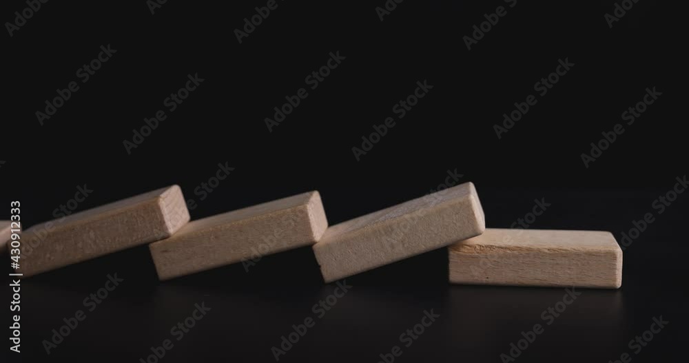 4K Video slow motion close up domino effect to make king chess falling. Concept for business falling and disruption. 4K Video slow motion close up domino effect to make king chess falling. Concept for business falling and disruption.