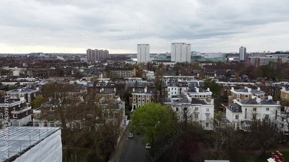 Ascending aerial shot over residential area in London and high rising blocks in background. Notting Hill,London. Ascending aerial shot over residential area in London and high rising blocks in background. Notting Hill,London.